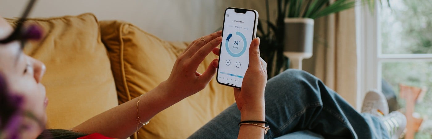 Person looking at smartphone on a sofa