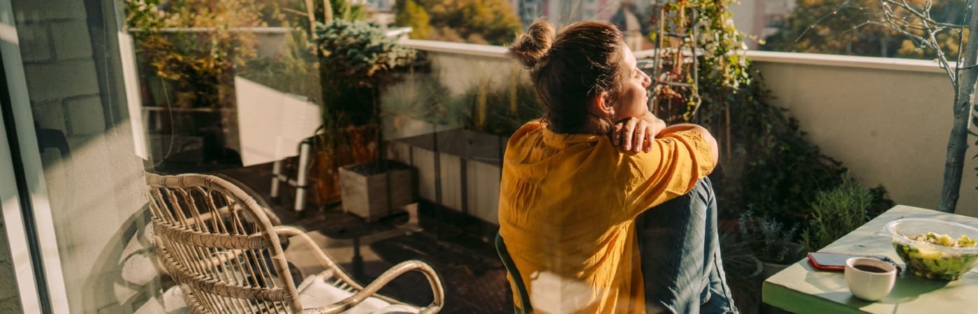 Woman sitting on a balcony enjoying the view